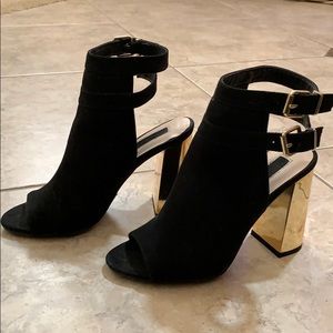 Black high heel with golden heels